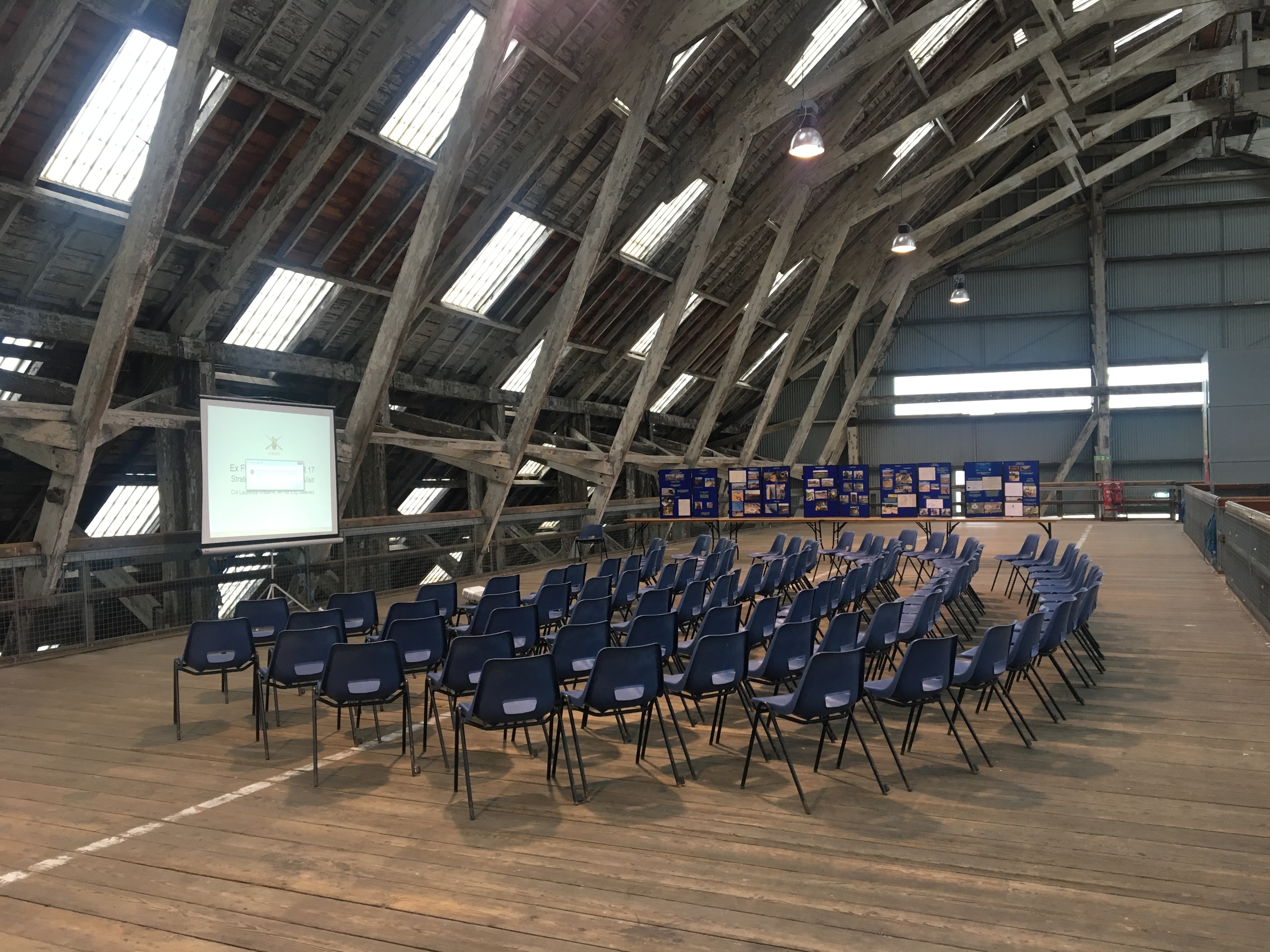 Rustic Slip Mezzanine venue with blue chairs, perfect for meetings and workshops.