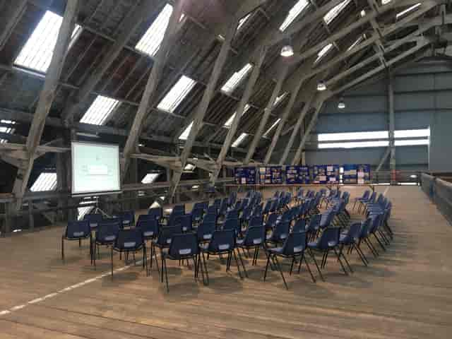 Rustic Slip Mezzanine venue with blue chairs, perfect for meetings and workshops.