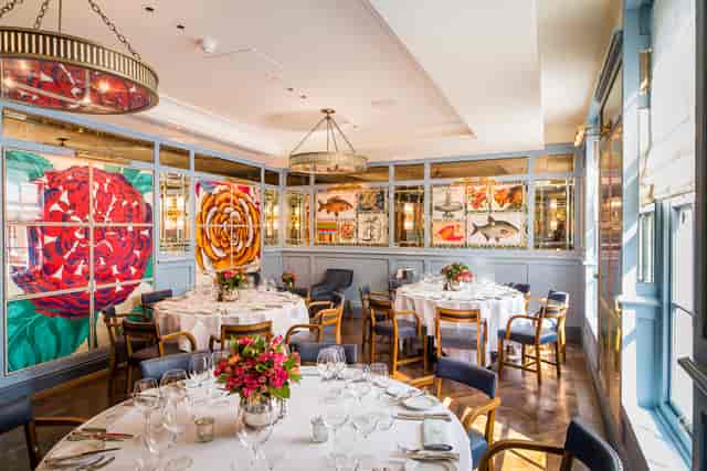 Isabella Room at The Ivy Café Richmond, elegant dining space for events with floral centerpieces.