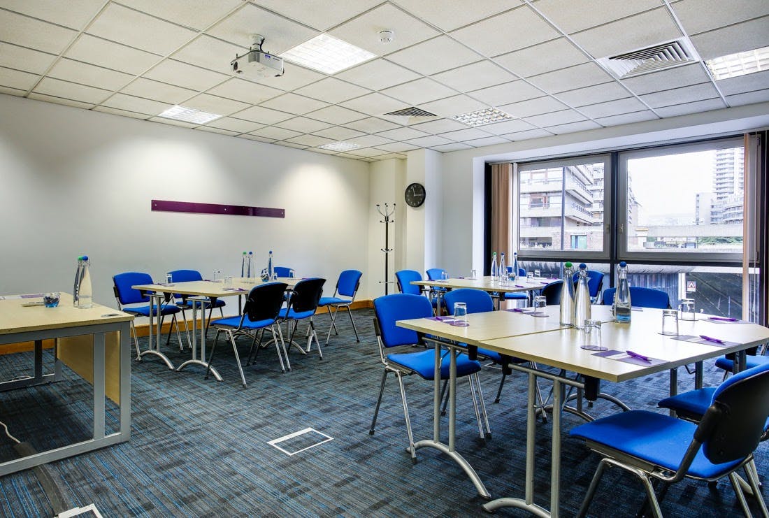 Electra Room at CCT Venues, Barbican: bright meeting space for events with blue chairs.