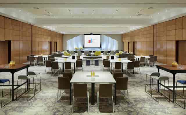 Versatile meeting space at London Heathrow Marriott with large screen for corporate events.