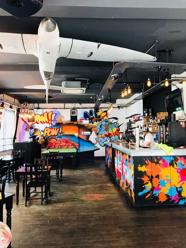 Vibrant Main Bar in Shoreditch with colorful graffiti, ideal for networking events.