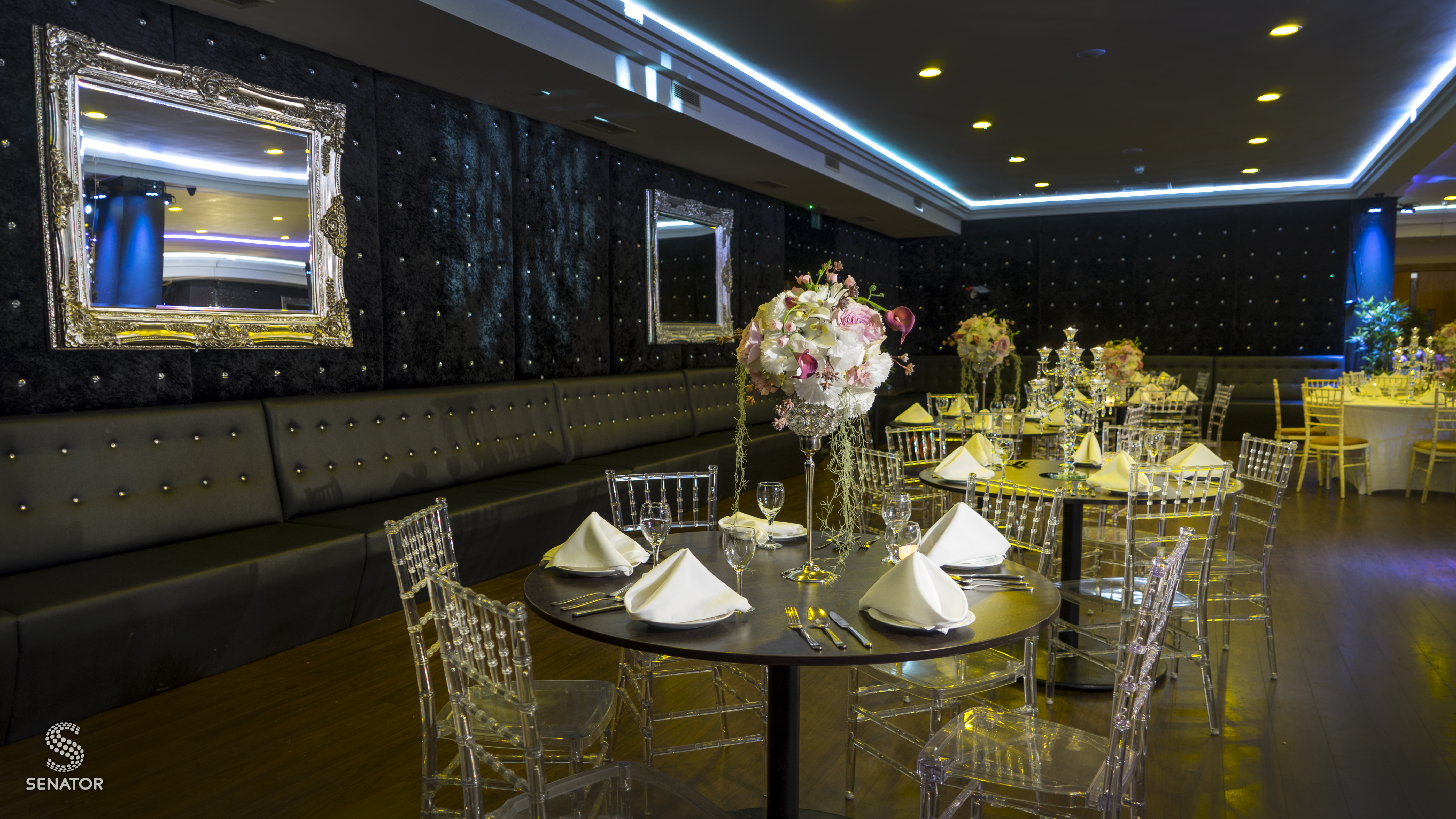 Elegant event space with round tables, ideal for weddings and Bar Mitzvahs. - Banner