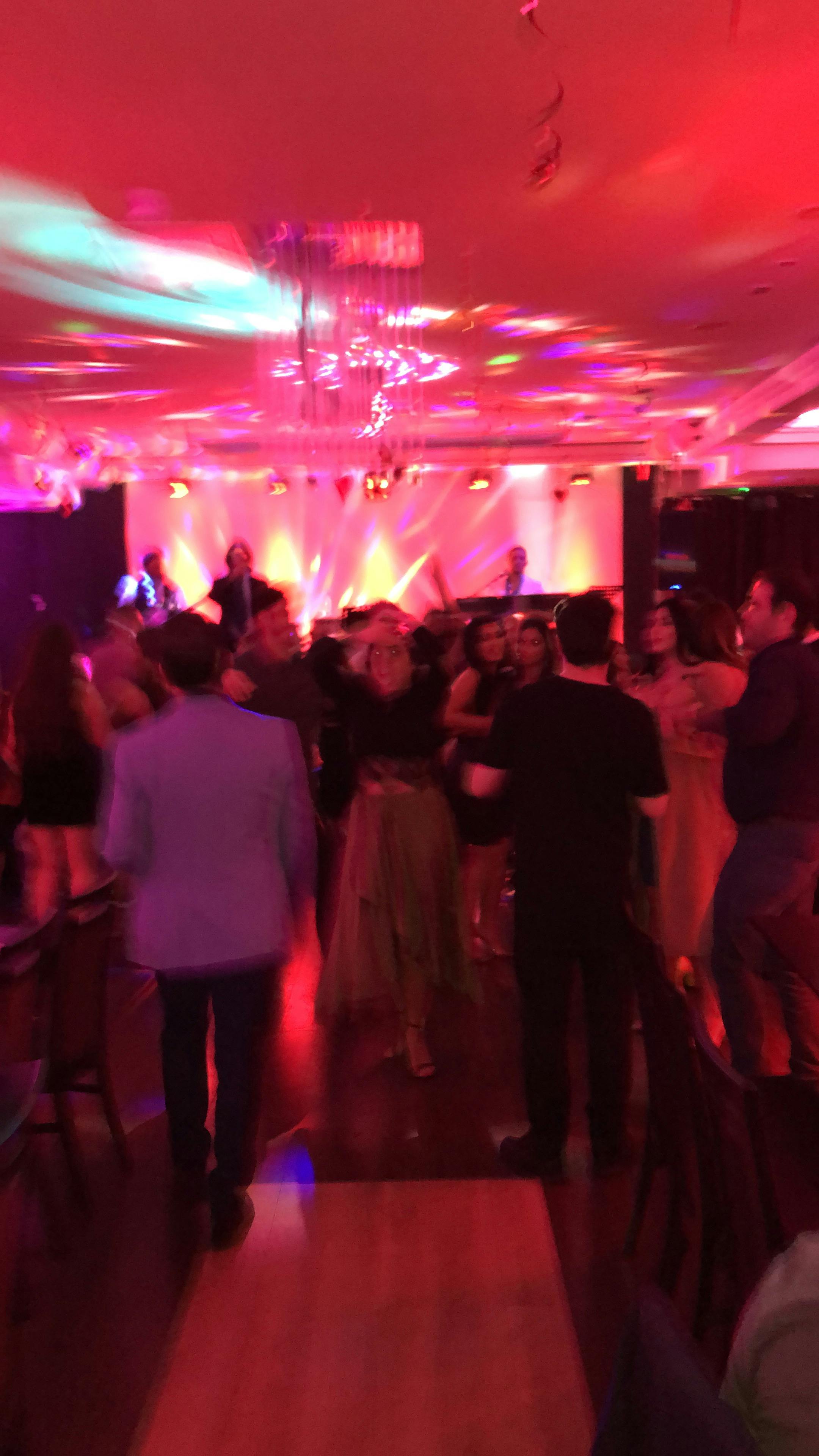 Vibrant nightlife event in Hagefen with guests dancing under dynamic lighting.