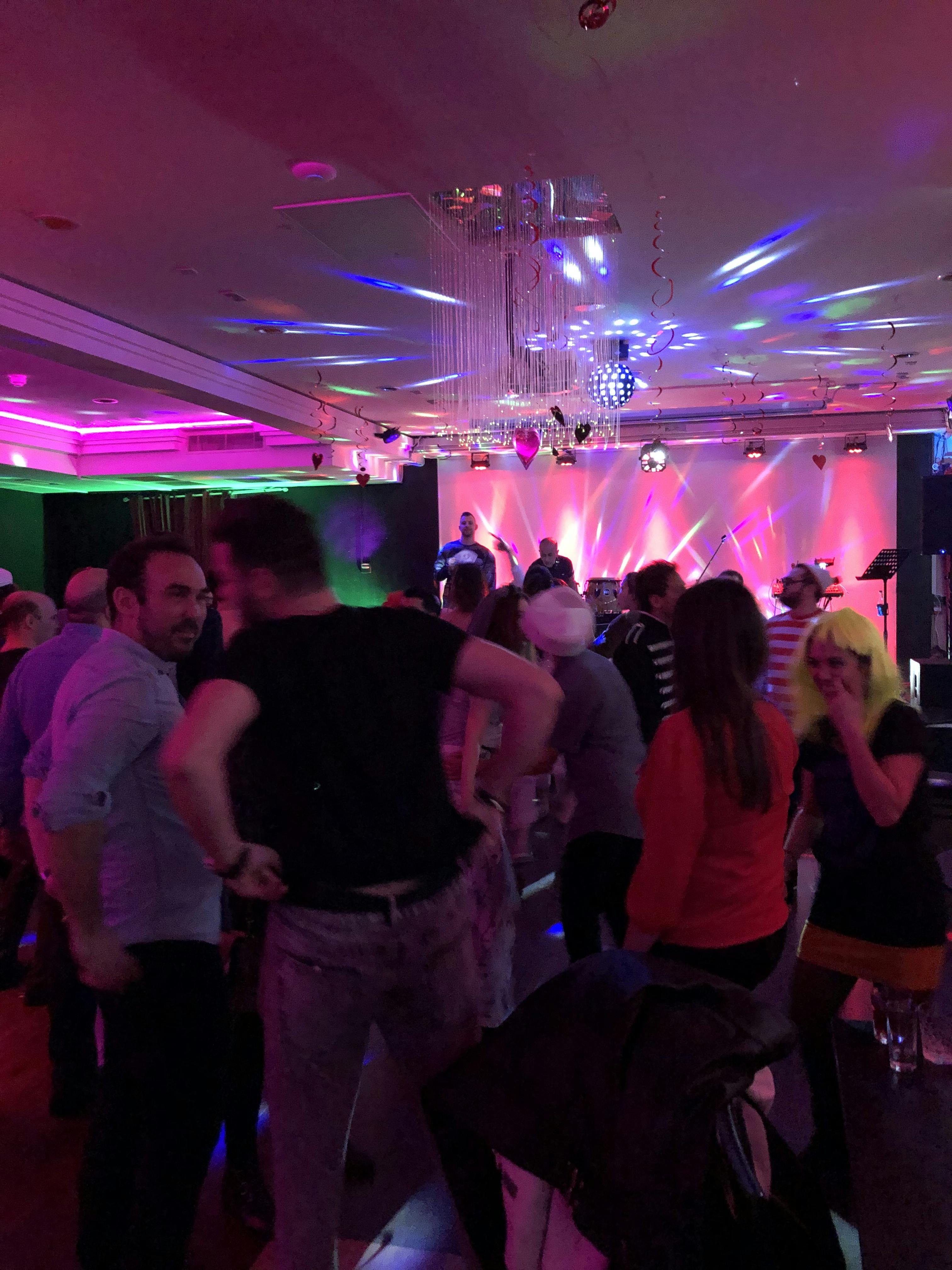 Vibrant nightlife event in Hagefen with dancing under colorful lights.