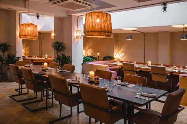 Intimate corporate dinner at Record Room, Caravan Fitzrovia featuring warm residential lighting.