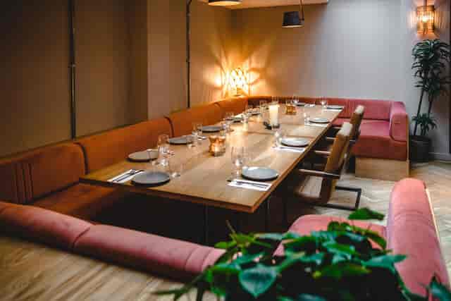 Private dining room with plush banquette seating for corporate events and team dinners.