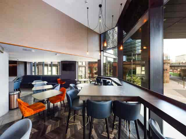 Modern Embankment Lounge with large windows, perfect for networking events and casual meetings.