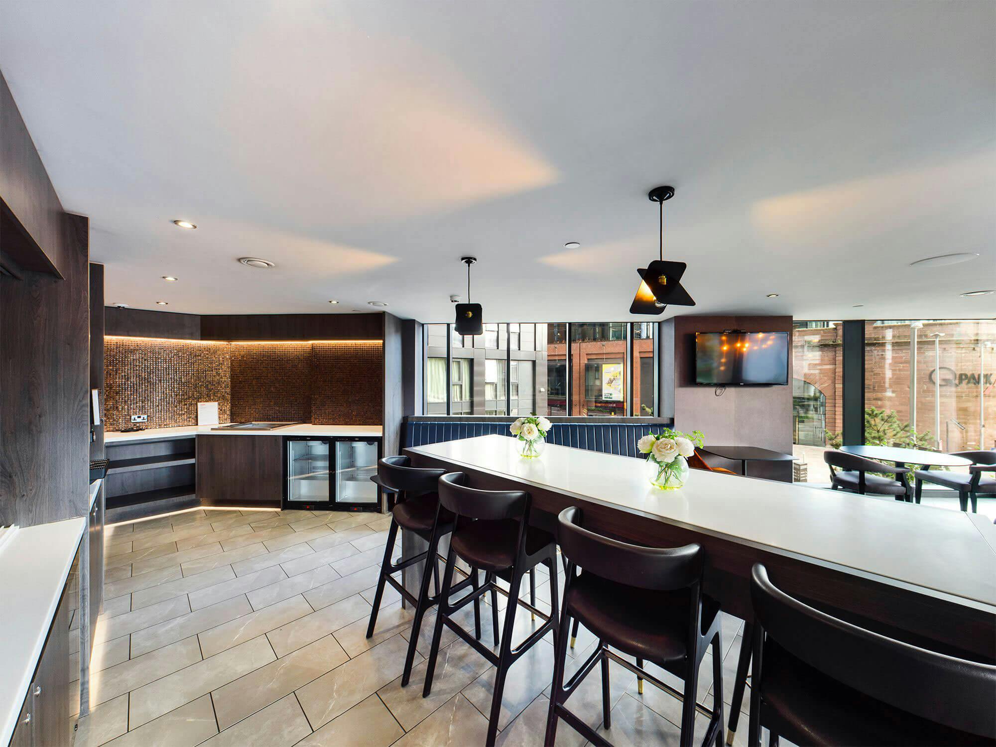 Modern Embankment Lounge with sleek kitchen, ideal for networking events and meetings.