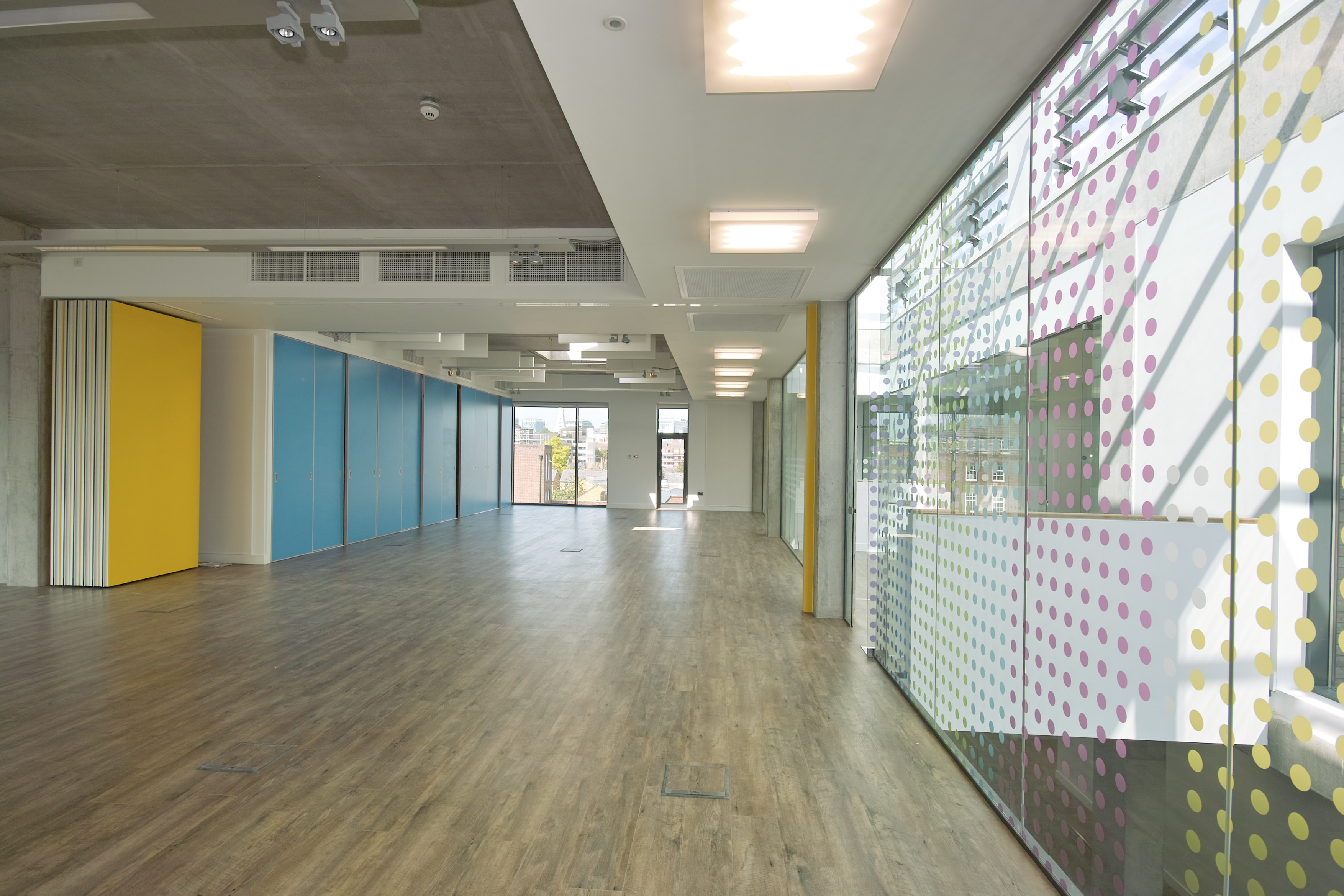 Modern Community Hall in Osmani Trust, featuring large windows for events and gatherings. - Banner