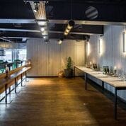 Industrial-chic breakout space with high-top tables for cocktail receptions and networking events.