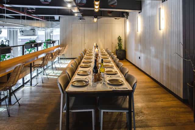 Modern industrial boardroom at Mezzanine, Caravan City, perfect for corporate dinner events.