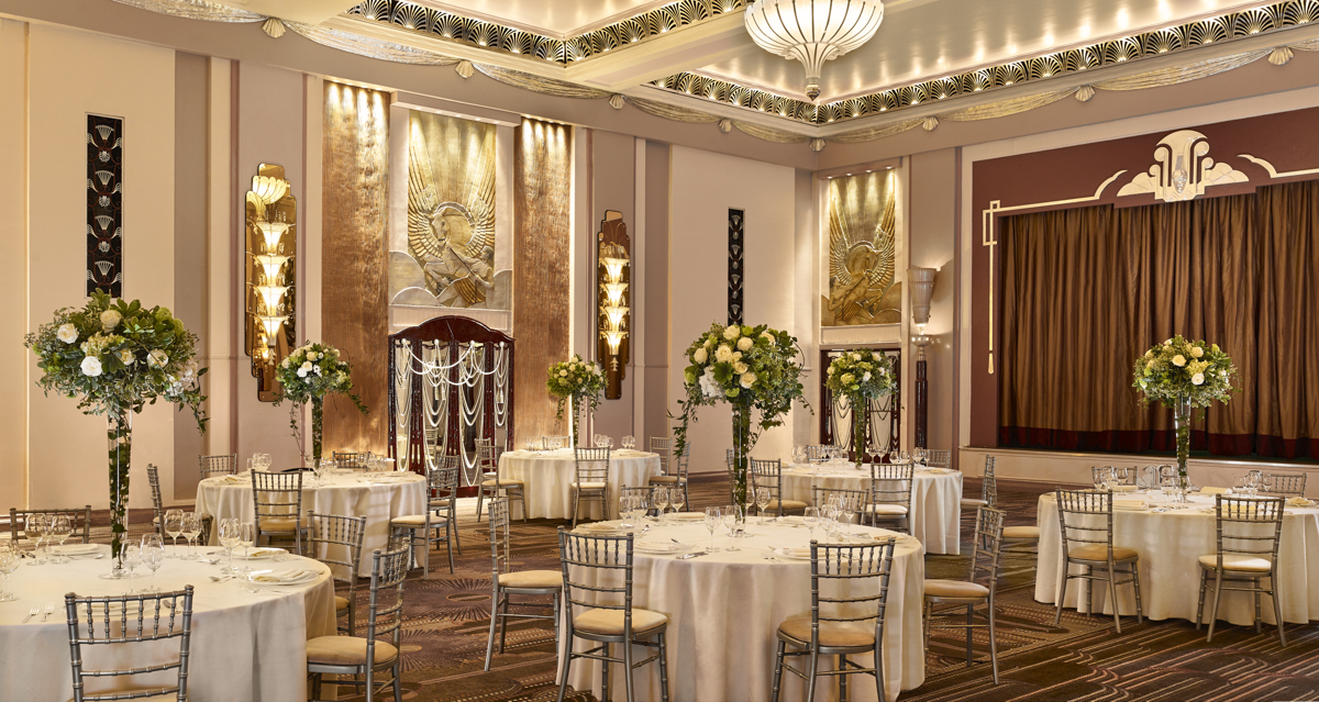 Elegant ballroom with floral centerpieces, ideal for weddings and corporate events.