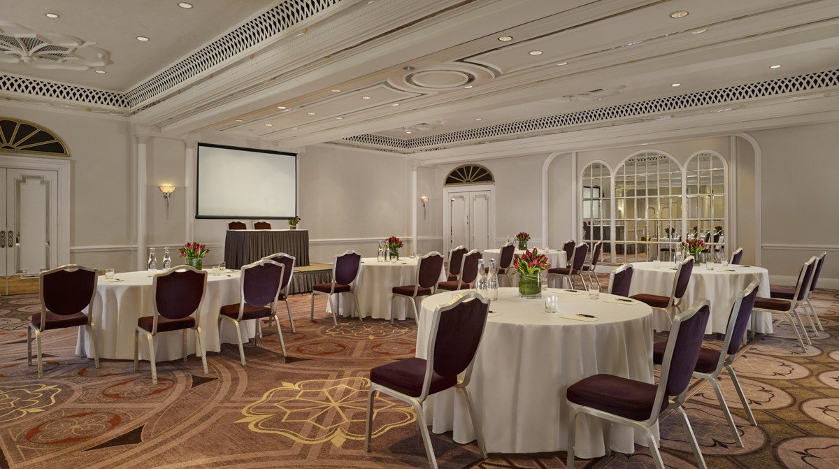 Elegant Tudor Rose event space with floral centerpieces for corporate meetings and gatherings. - Banner