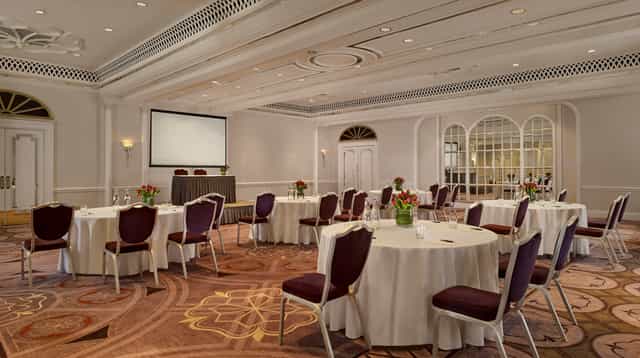 Elegant Tudor Rose event space with floral centerpieces for corporate meetings and gatherings.