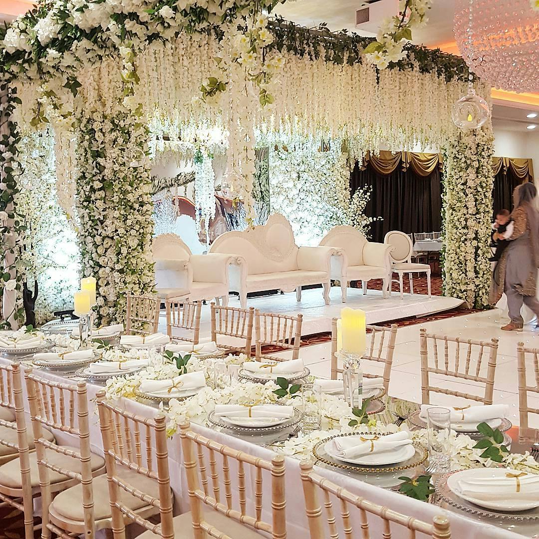 Elegant wedding venue with floral arrangements and white seating in The Willow's Ballroom.