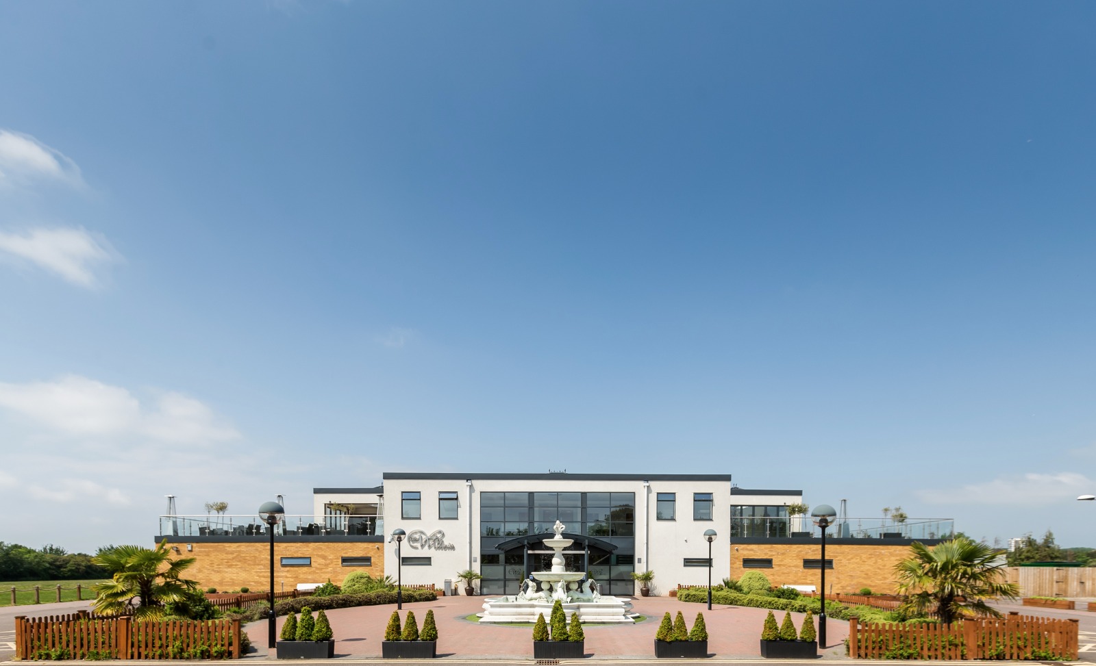 Modern event venue with large glass windows, ideal for corporate meetings and social gatherings. - Banner
