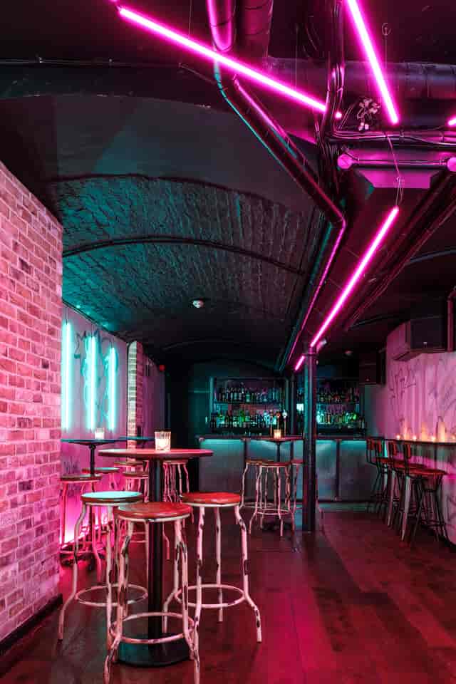 Stylish Function Room with exposed brick and neon lights for cocktail events in Farringdon.