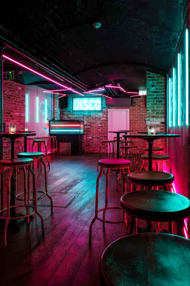 Modern Simmons Farringdon function room with neon lighting for networking events and parties.