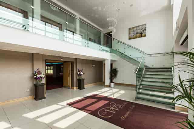 Premier Suite lobby with elegant chandelier, ideal for events and networking.