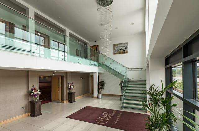 Elegant Premier Suite lobby with natural light, ideal for networking events and receptions.