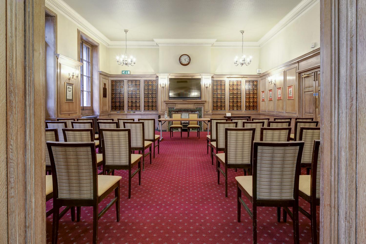 Meeting room at The Holden, featuring wooden paneling for corporate events and workshops.