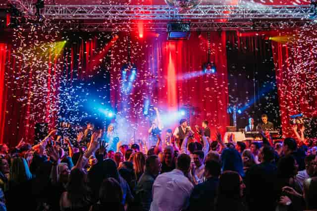 Vibrant crowd at The Point, Emirates Old Trafford, celebrating a gala event with confetti.