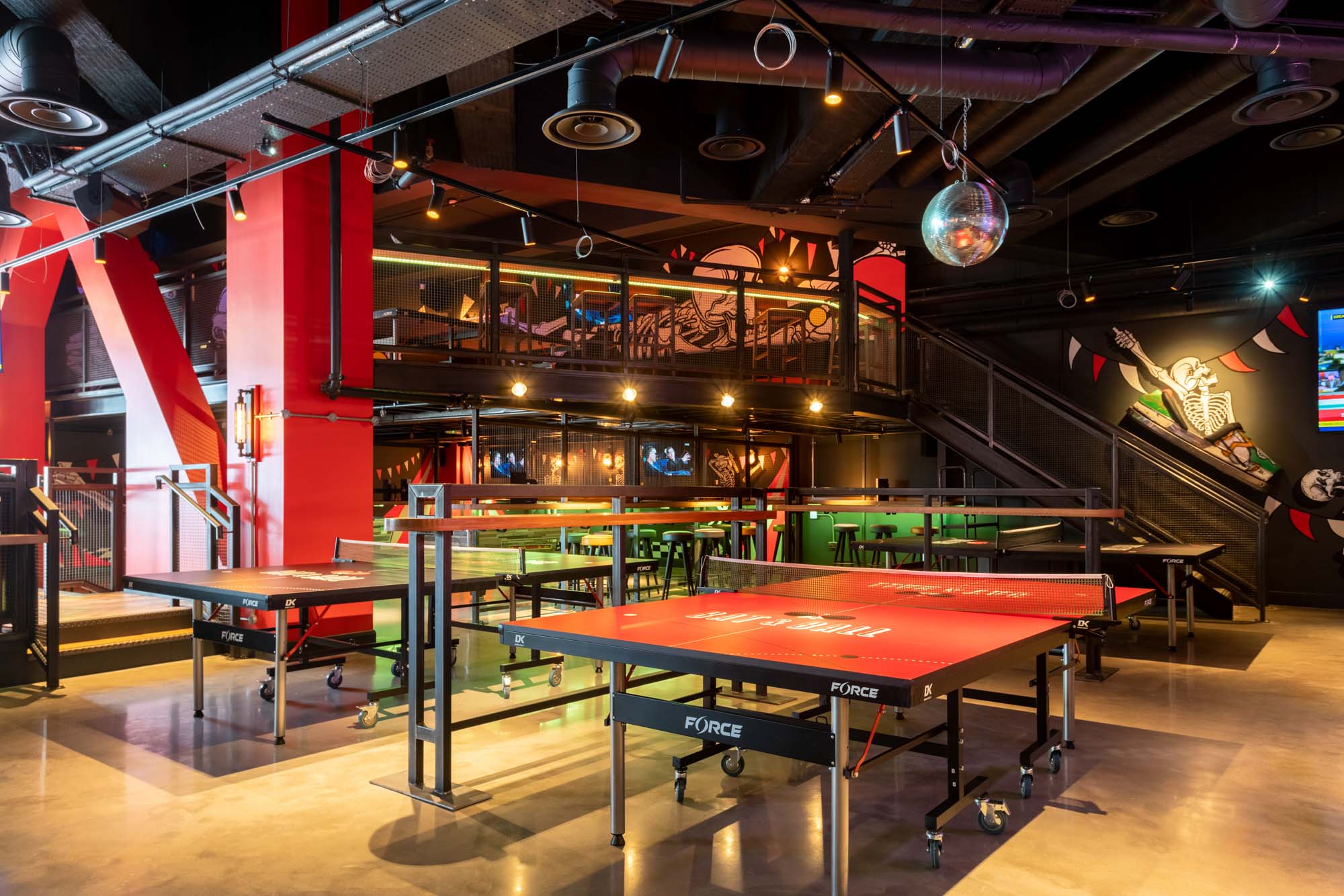 Vibrant event space with ping pong tables for dynamic parties and team-building activities. - Banner