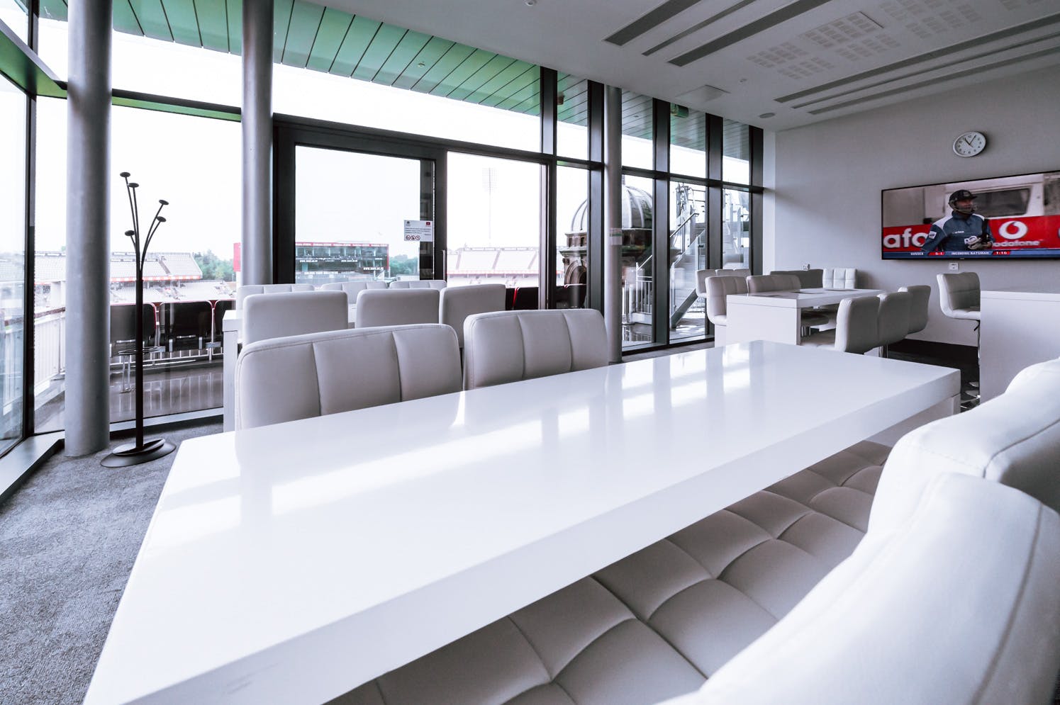 Modern meeting space at Emirates Old Trafford with a sleek white table and natural light.