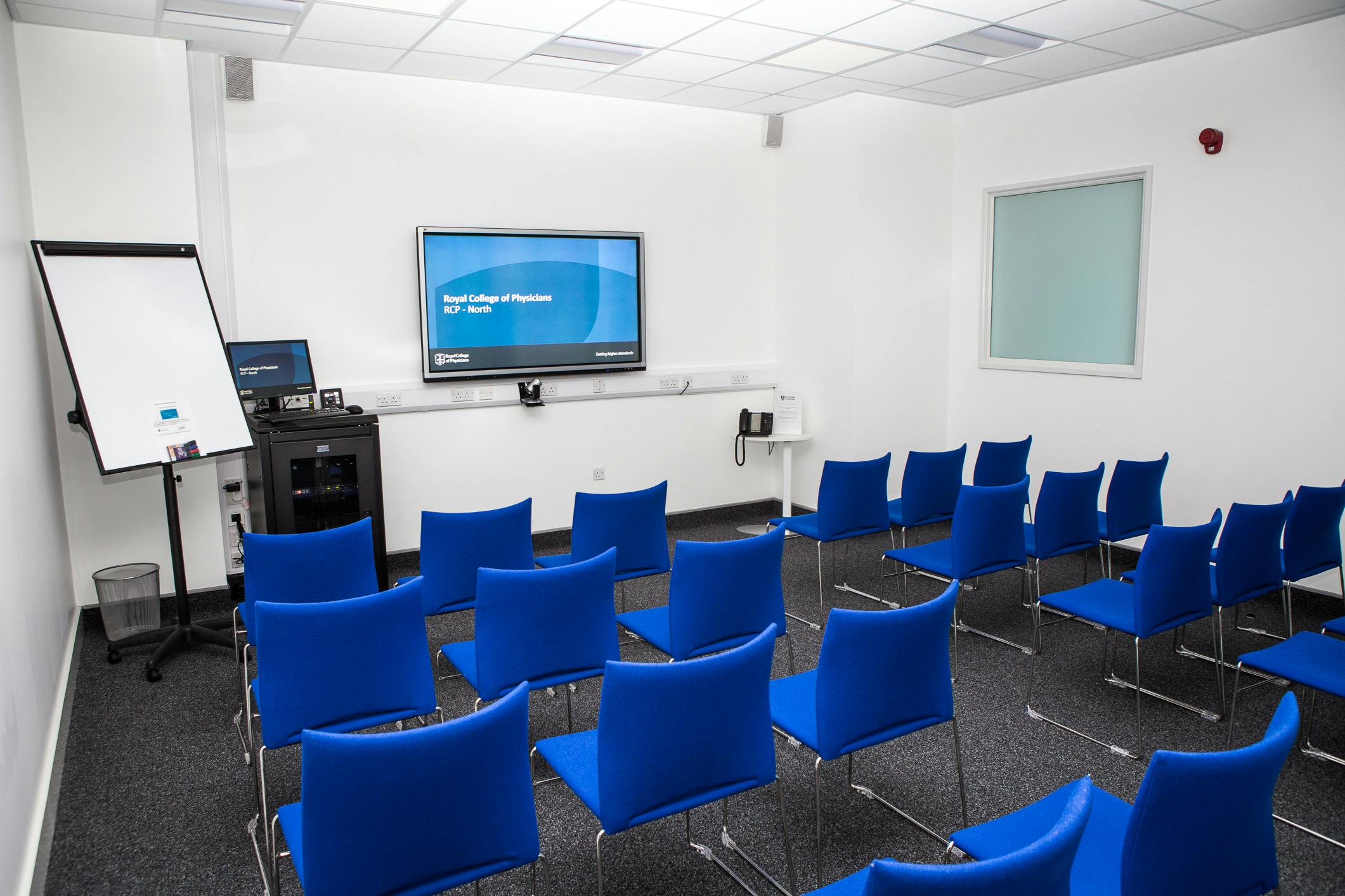 Modern Sheffield Room with blue chairs for presentations and workshops at RCP North.