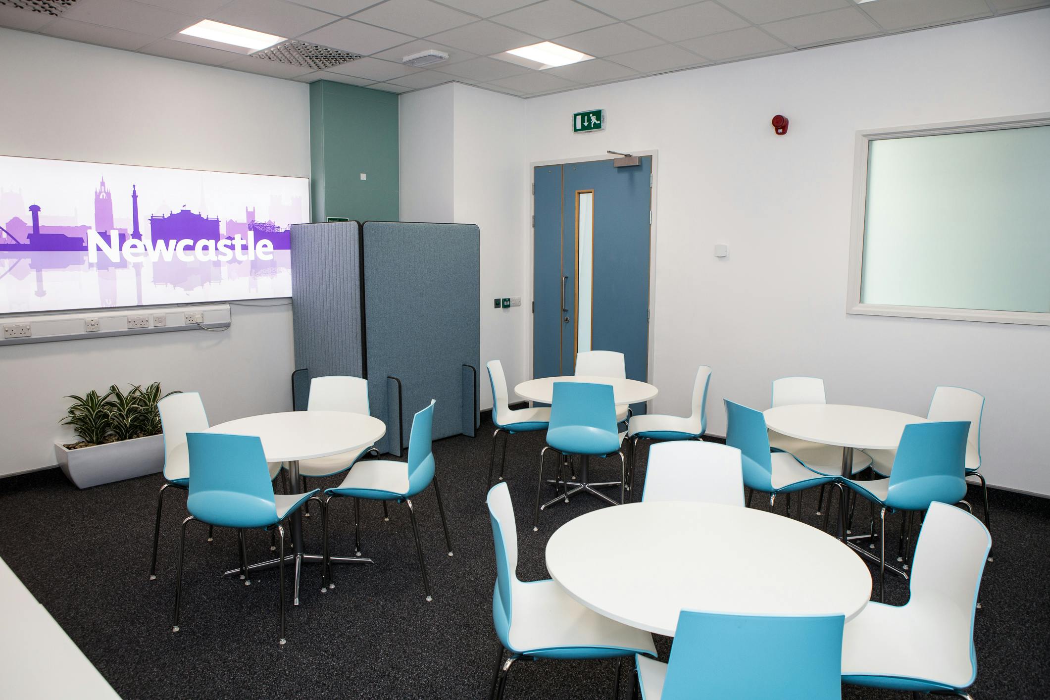 Modern meeting space with round tables, ideal for workshops in RCP North, Newcastle.