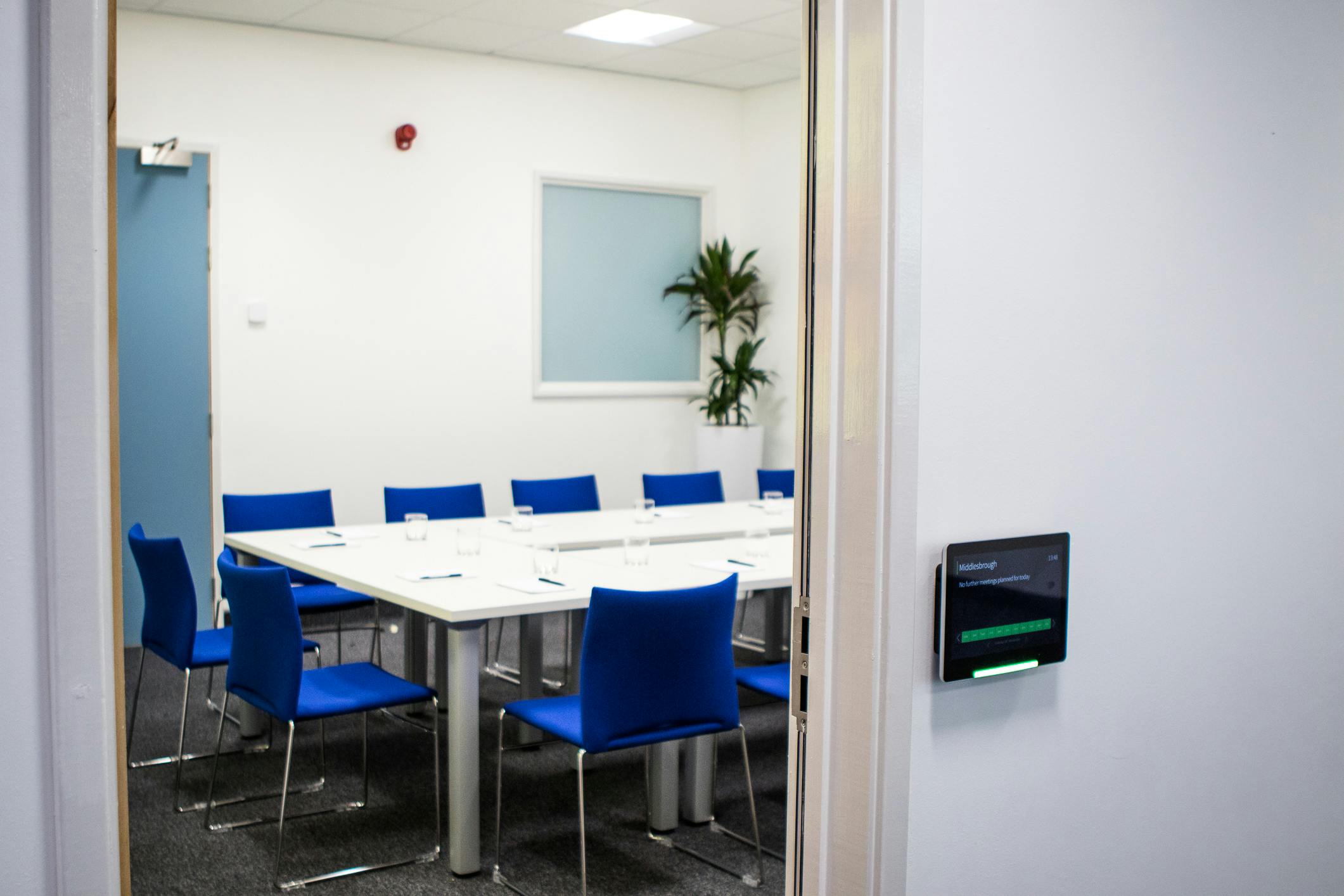 York Room in RCP North: modern meeting space with large table and blue chairs for events.