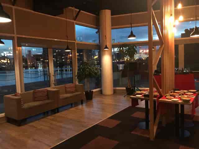 Stylish event space with large windows, ideal for networking and social gatherings.