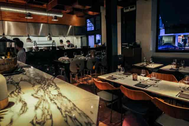 Modern sushi bar with elegant marble, ideal for corporate dinners and intimate gatherings.