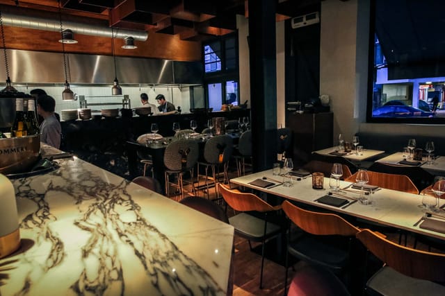 Modern sushi bar with warm lighting, ideal for intimate gatherings and corporate events.