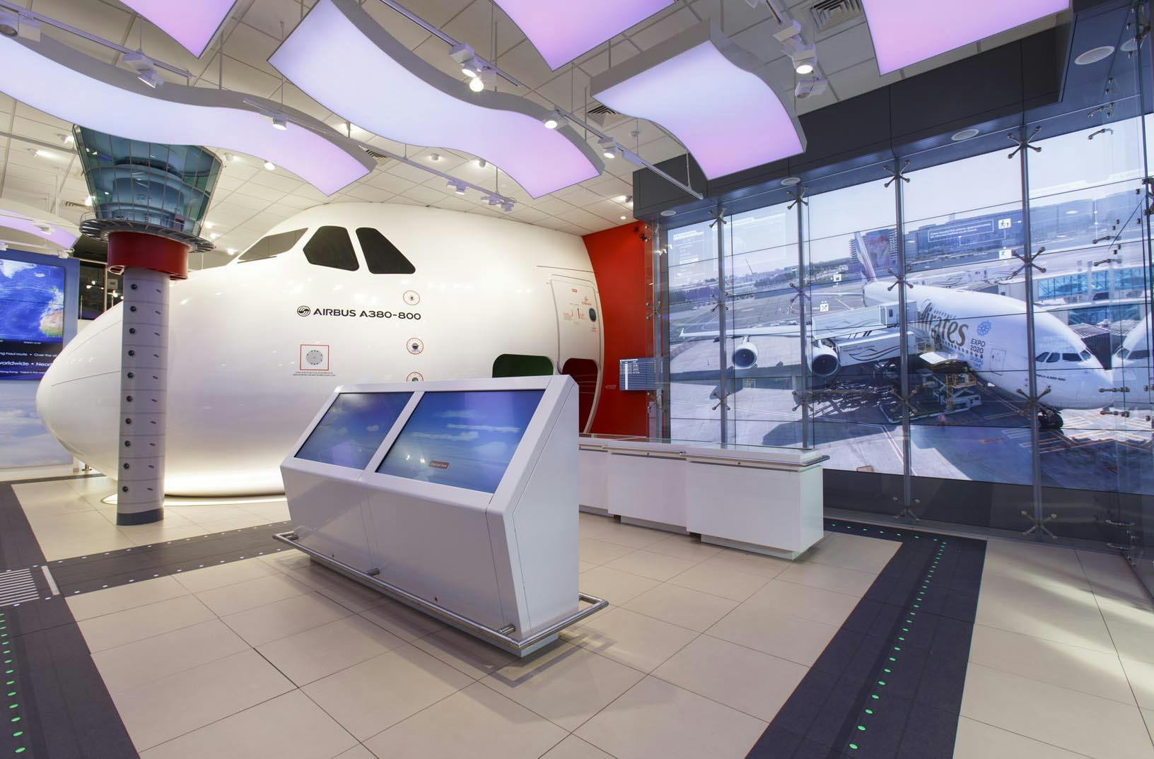 Modern aviation-themed exhibition space with a realistic cockpit for corporate events.