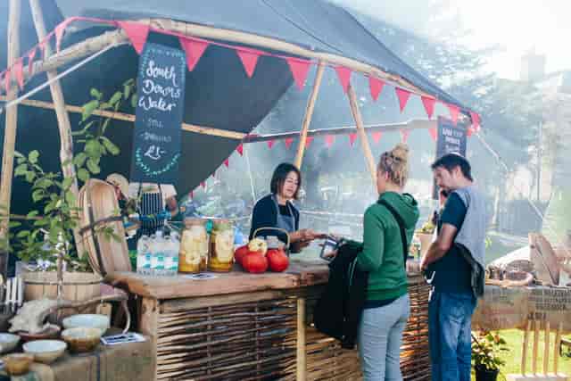 Vibrant outdoor market stall at Proud Country House for community events and networking.