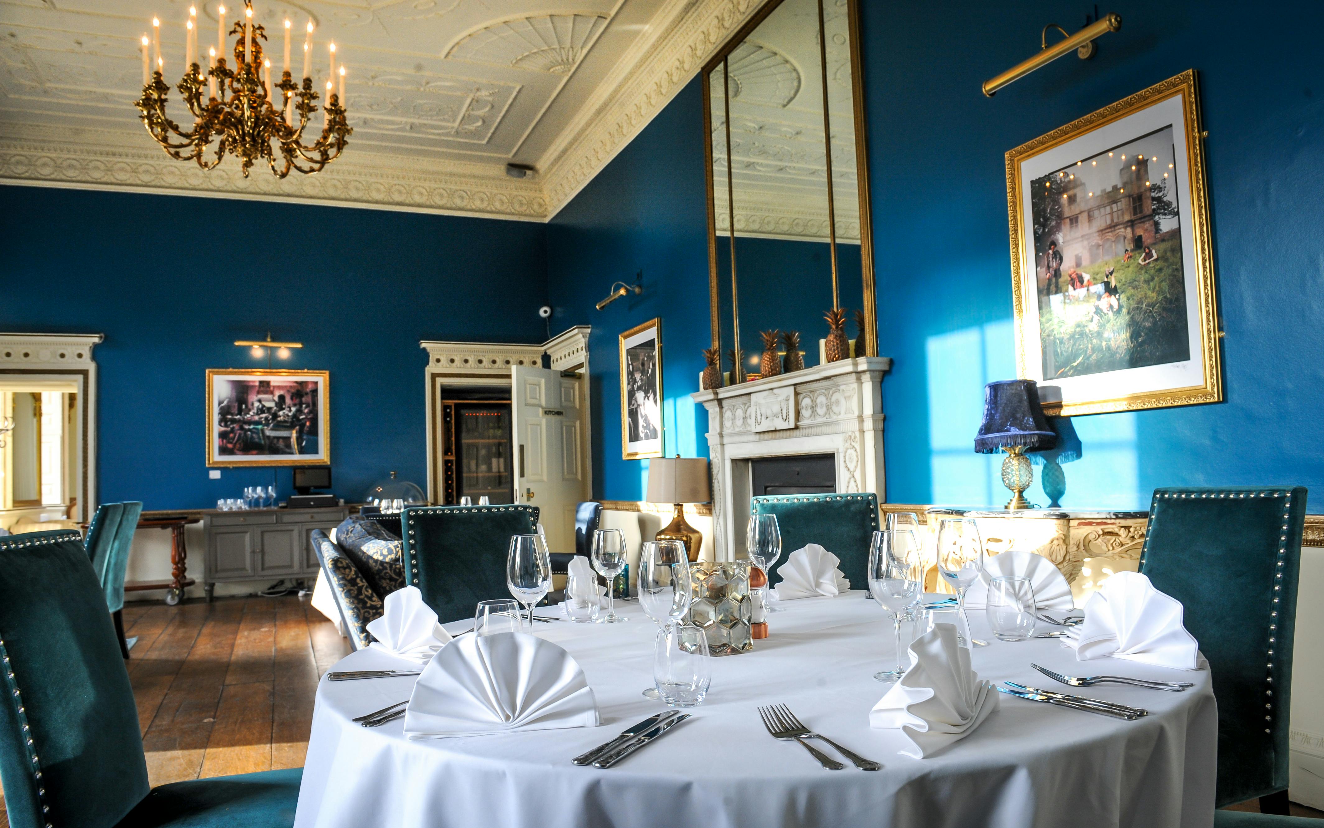 Elegant dining room with blue walls, perfect for upscale events and meetings.