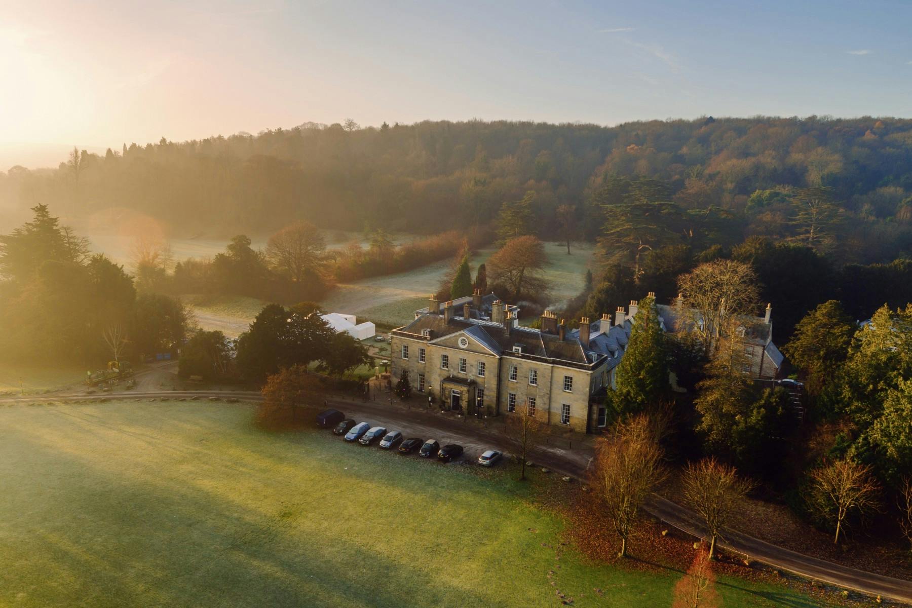 Stunning country estate venue for upscale meetings and weddings, surrounded by lush greenery.