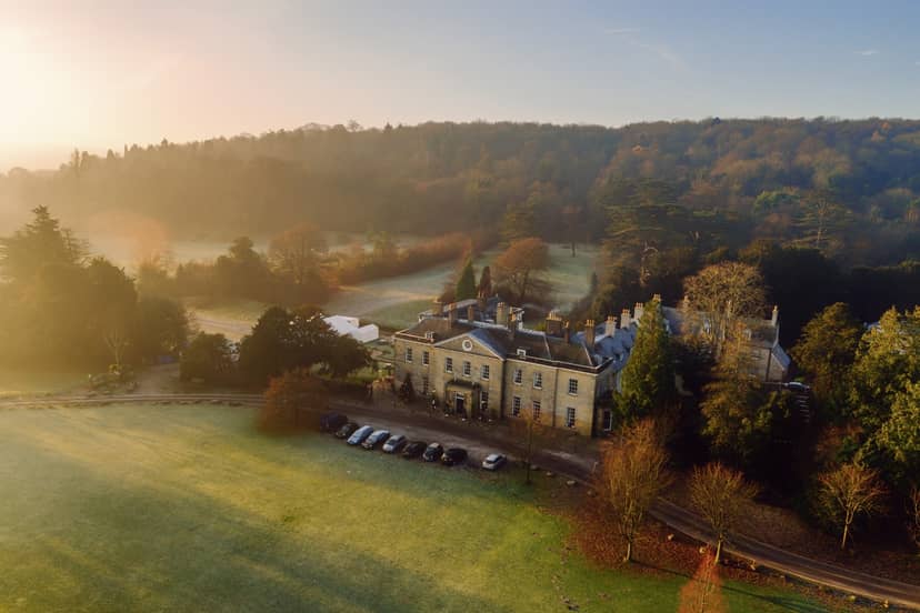 Stunning country estate venue for upscale meetings and weddings, surrounded by lush greenery.