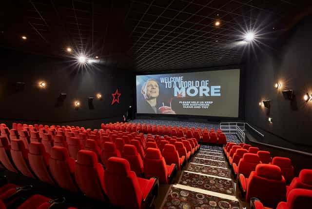 Medium screen cinema auditorium with plush red seating for corporate events in Birmingham.