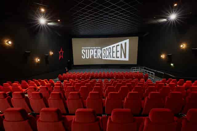 Medium screen cinema auditorium with plush red seating for film screenings and corporate events.