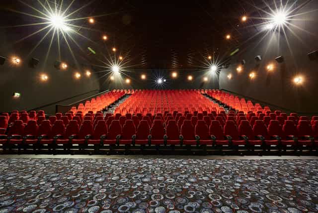 Large screen theater with red seating in Cineworld Birmingham for events and screenings.