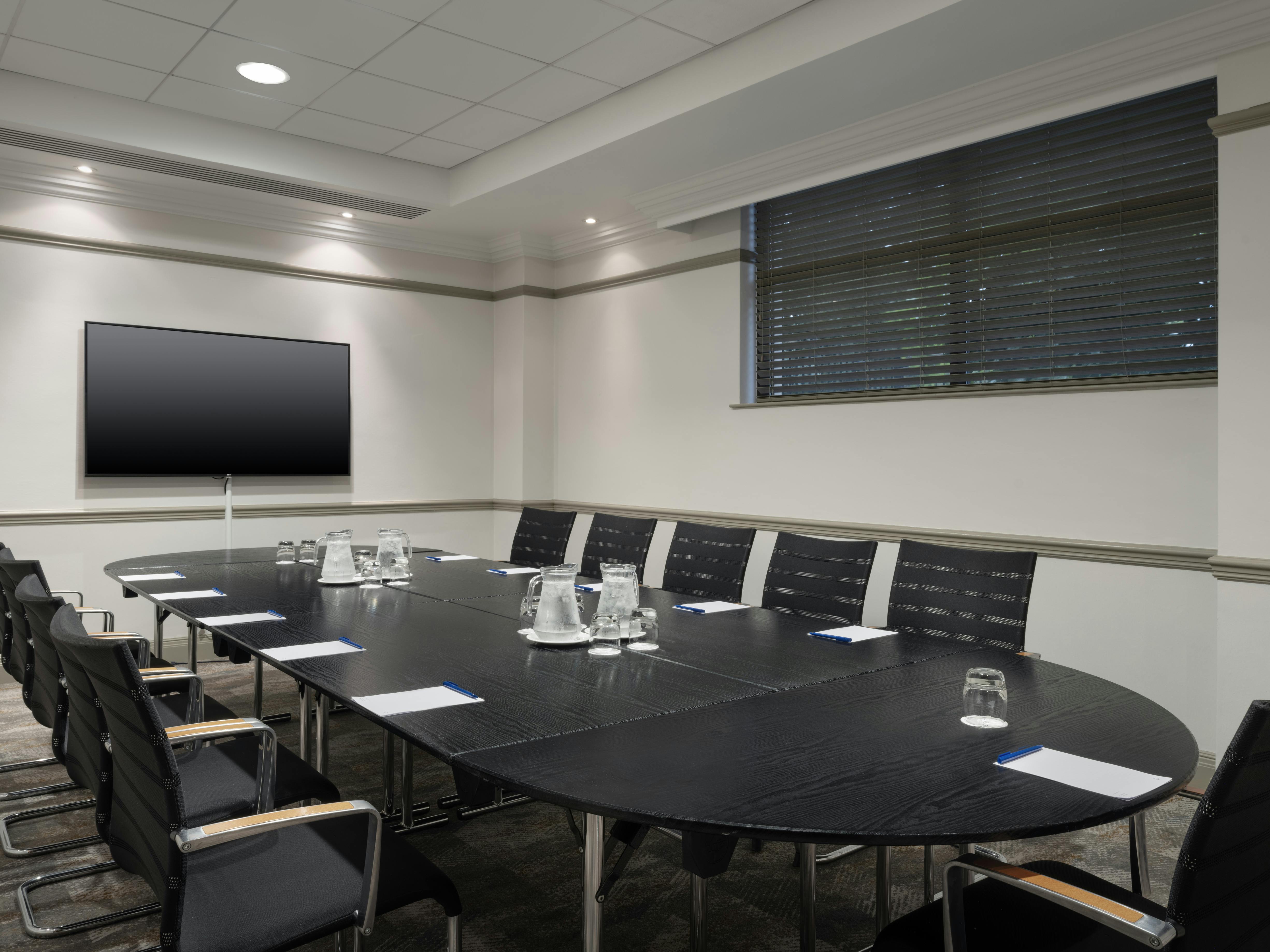 Modern conference room with oval table at Delta Hotels Liverpool for professional meetings.