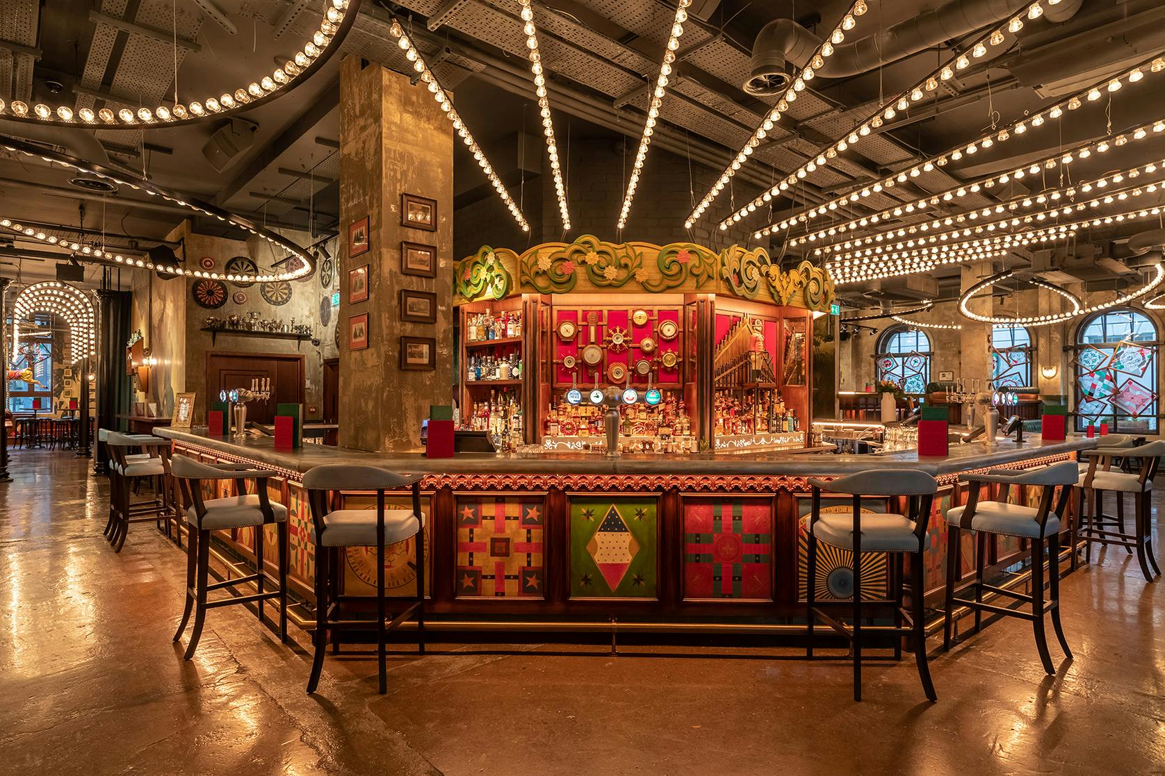 Vibrant bar area in Flight Club Manchester, perfect for networking events and gatherings.