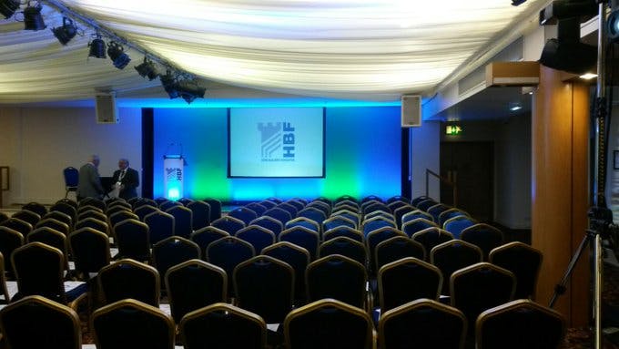 Conference room at The Marquee, DW Stadium, with blue chairs for presentations and networking.