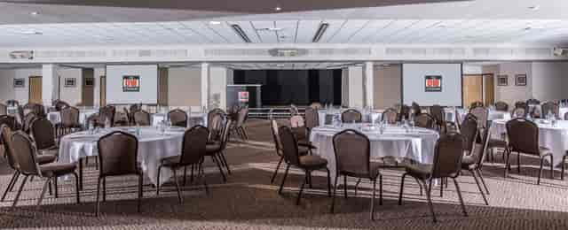 DW Sports Fitness Lounge event space with round tables, ideal for meetings and banquets.