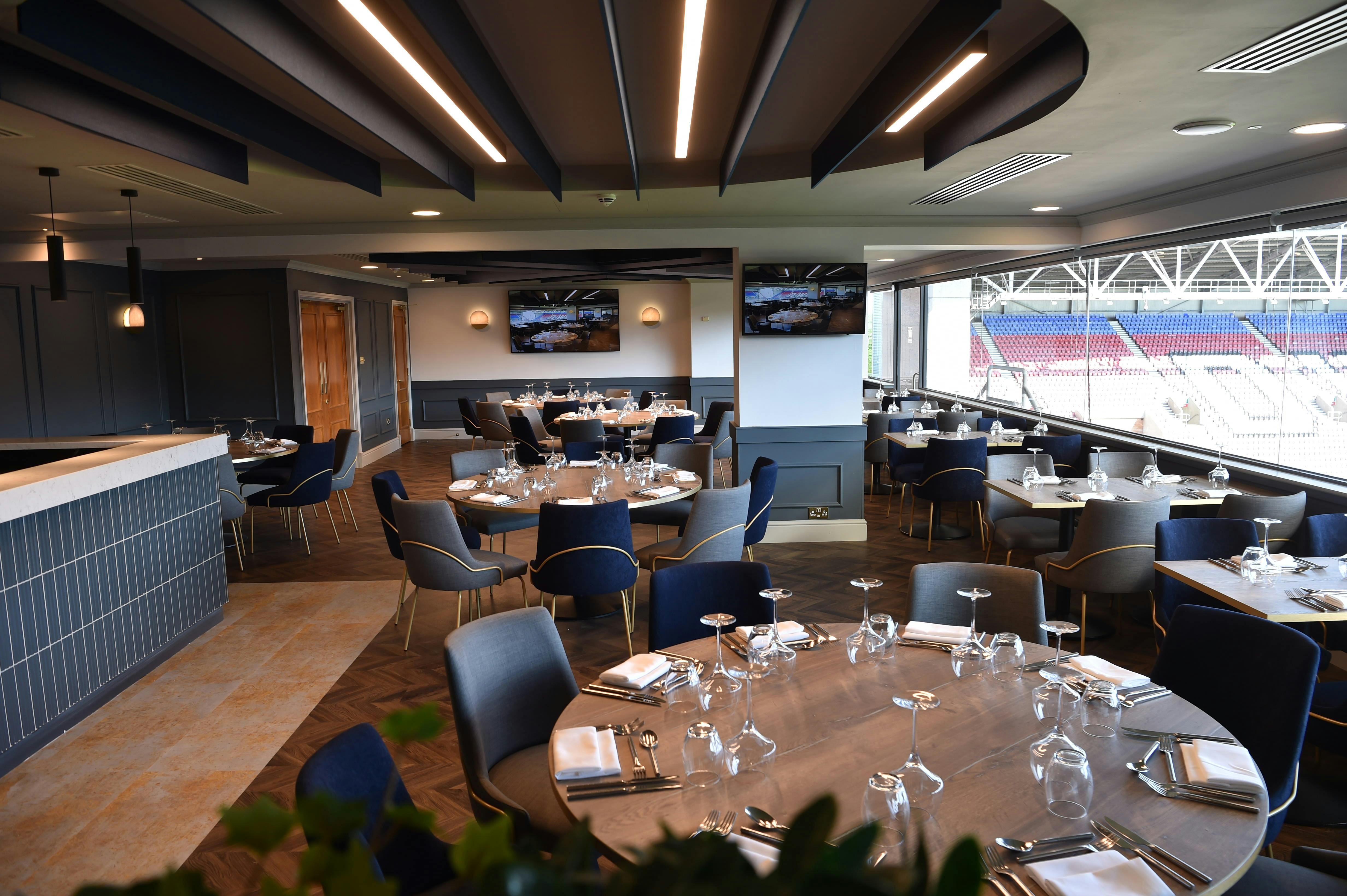 Chairman's Club at DW Stadium: elegant event space with round tables for corporate gatherings.