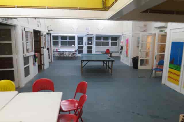 Versatile meeting space with a ping pong table for casual gatherings and workshops.