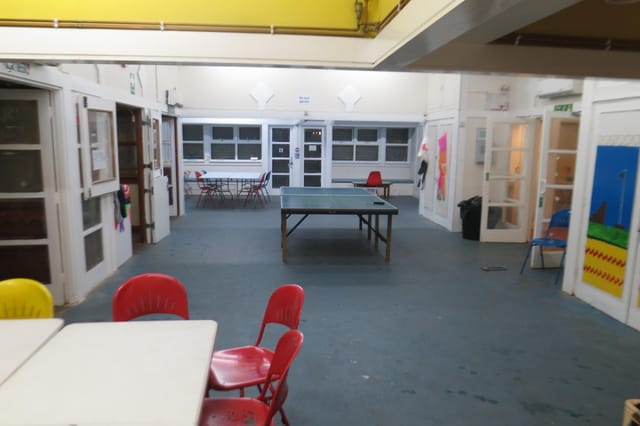 Versatile meeting space with a ping pong table for casual gatherings and workshops.
